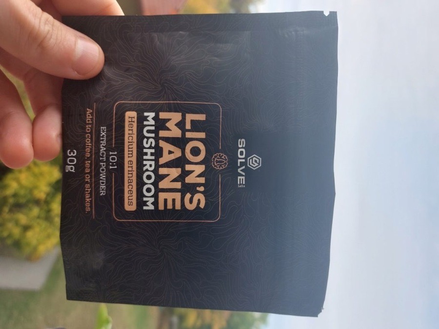 Buyer holding the Solve Labs Lion's Mane powder pouch